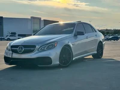 2014 Mercedes-Benz E-Class E63SAMG in Silver with Black interior, front three quarter view
